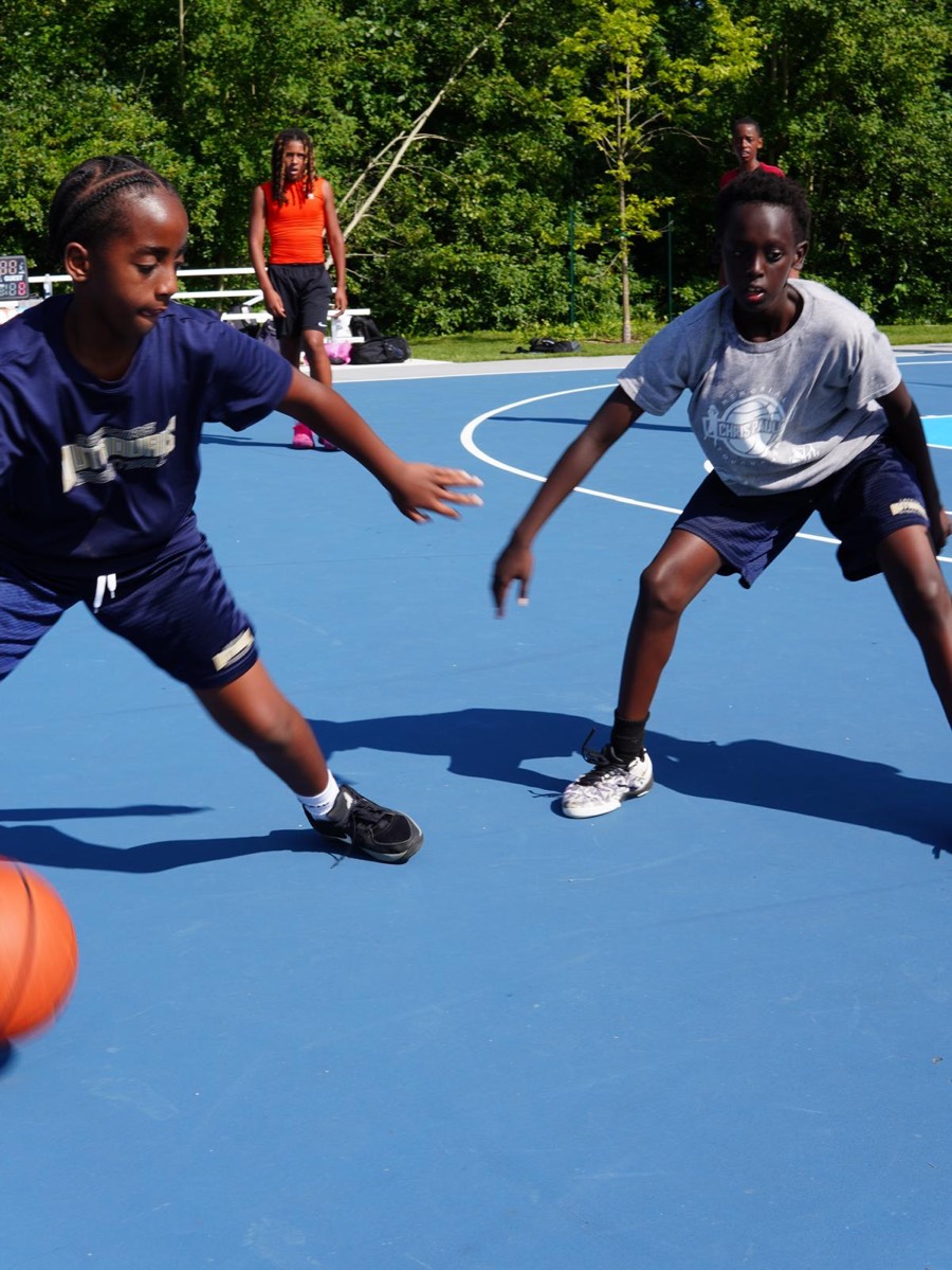 Players guarding each other during a game at the Check Up summer community event
