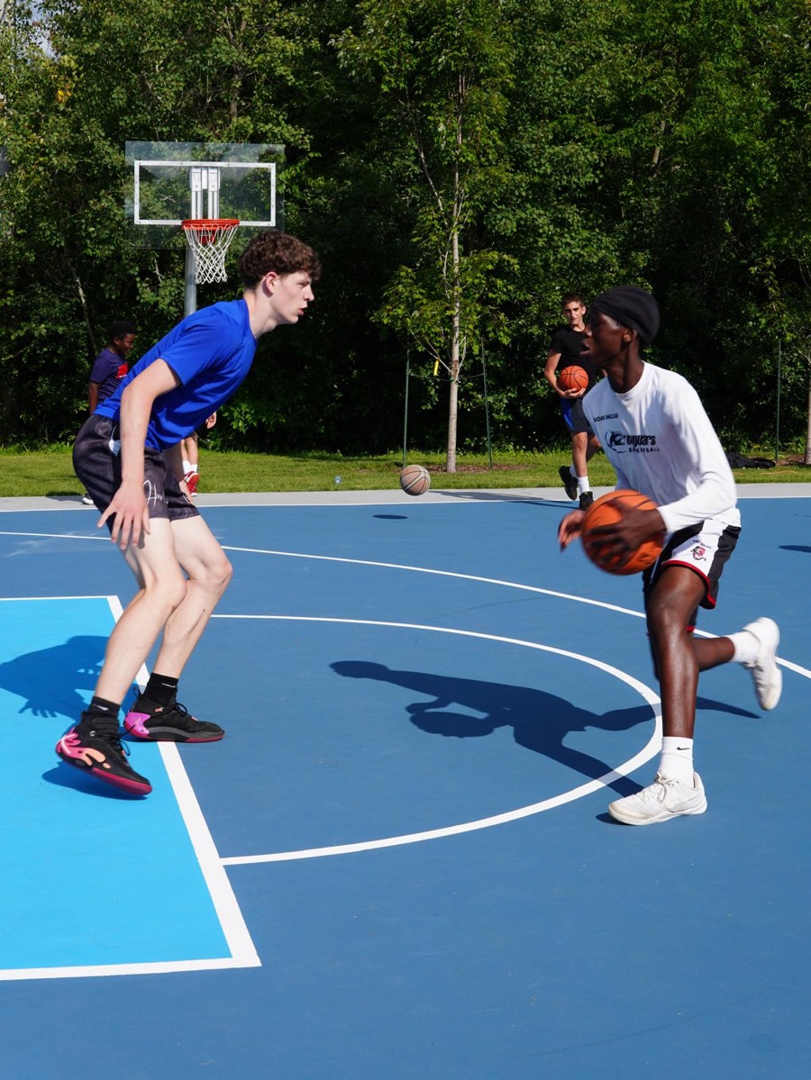 A player dribbling past a defender during a game at a Check Up community event